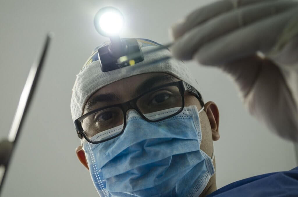  A dentist about to treat their patient who they gained through solid dental SEO