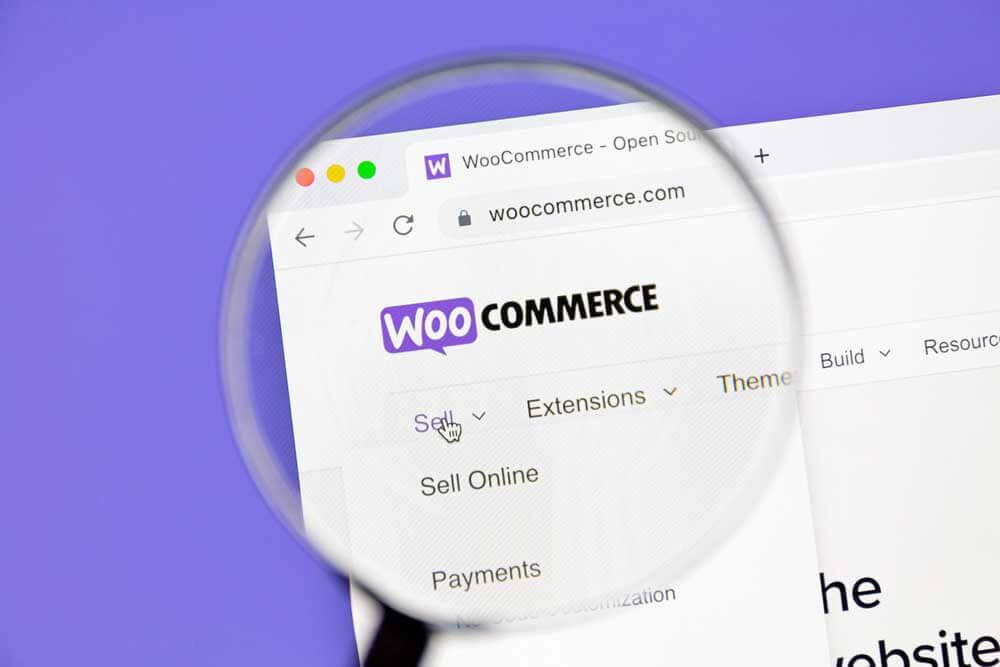 WooCommerce homepage on a computer screen with a magnifying glass to demonstrate Woocommerce SEO services