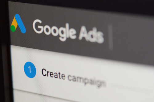 A screen showing the Google Ads banner above a window that shows the first step to creating an Google ads campaign.